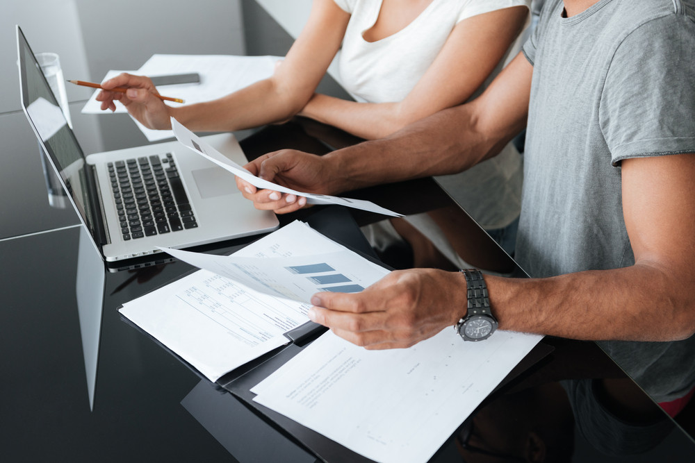 Cropped image of loving young couple analyzing their finances wealth management
