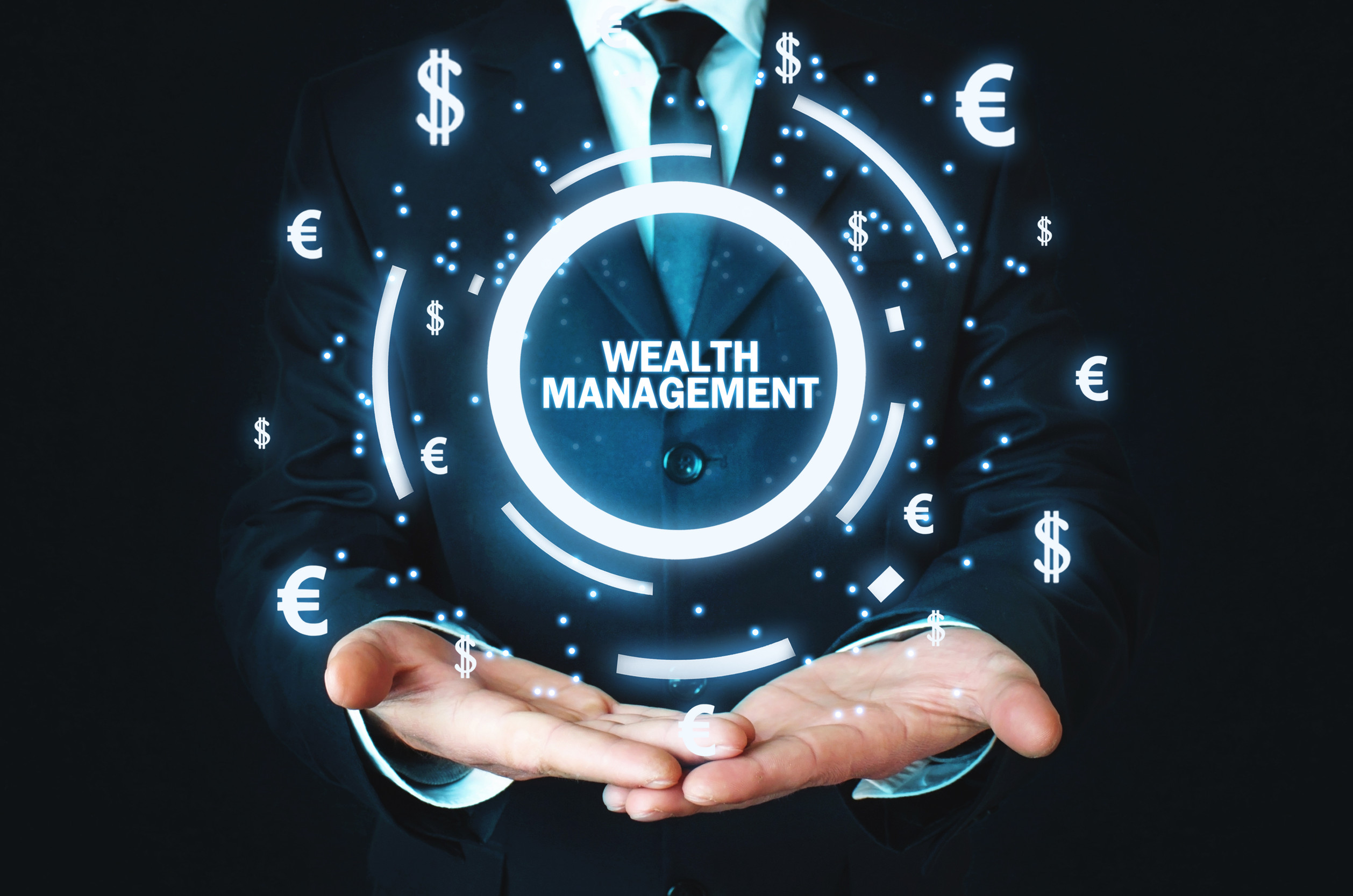 Businessman holding Wealth Management word with currency symbols Businessman holding Wealth Management word with currency symbols